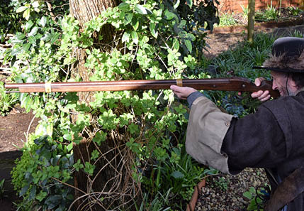 A man firing a musket on the family fun day